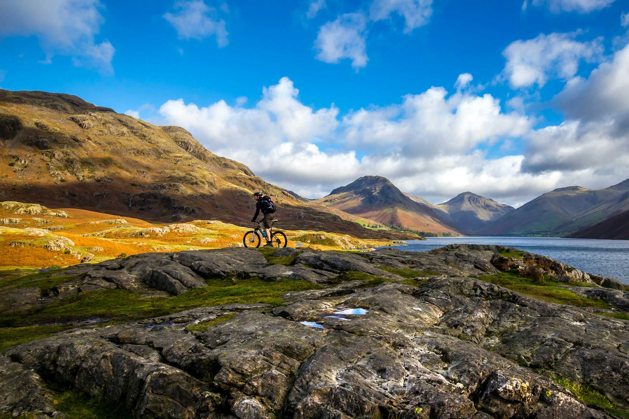 man on a mountain bike with epic mountain landscape